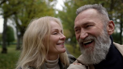 Portrait-of-senior-family-having-fun-outdoors.-Smiling-elderly-couple-walking