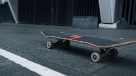 Skateboard-rolling-on-asphalt.-Black-skate-conceptual-for-street-sports.