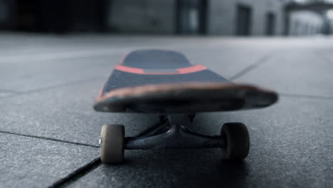 Skateboard-riding-outdoor.-Closeup-skate-stopping-in-middle-of-sidewalk.