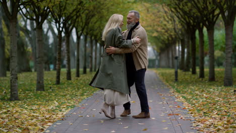 Happy-senior-couple-having-fun-in-autumn-park.-Elderly-people-dancing-outdoors