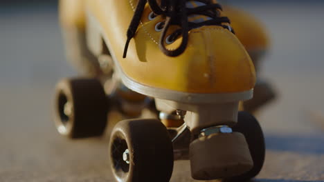 Yellow-roller-skates-closeup.-Stylish-boots-with-wheels-for-skating-in-summer.