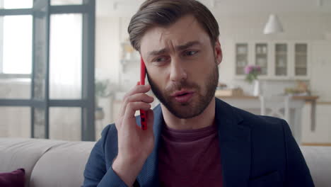 serious-businessman-talking-phone-at-home-office.-Man-discussing-business.