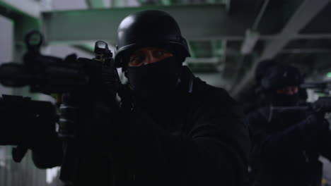 Anti-terrorist-squad-looking-through-scopes-on-automatic-rifles.-SWAT-police