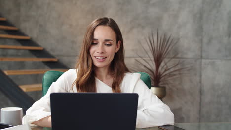 Smiling-business-lady-making-conference-call-on-laptop.-Girl-working-laptop.