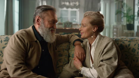Senior-couple-hugging-in-luxury-living-room.-Happy-old-people-spending-time