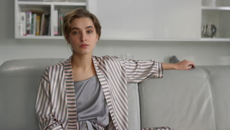 Pensive-girl-thinking-problems-rest-on-sofa-closeup.-Beautiful-lady-in-pajamas
