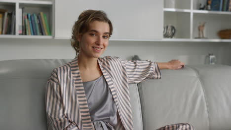 Attractive-lady-resting-living-room-closeup.-Relaxed-girl-posing-in-pajamas