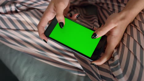 Girl-hands-playing-chroma-key-smartphone-closeup.-Person-texting-friend-on-sofa