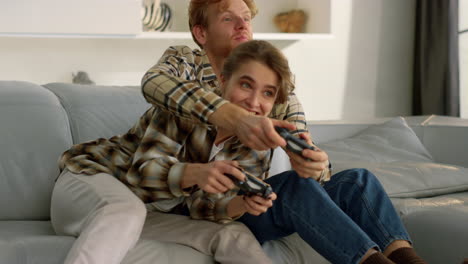 Emotional-friends-play-gamepad-video-game-at-home.-Joyful-family-time-together