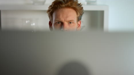 Closeup-focused-man-working-computer-at-home-office.-Pensive-manager-check-data