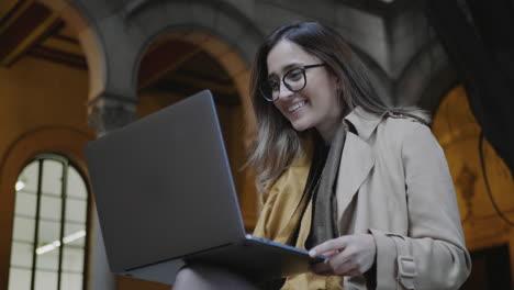 Student-receiving-good-news-on-laptop-at-university.-Businesswoman-using-laptop