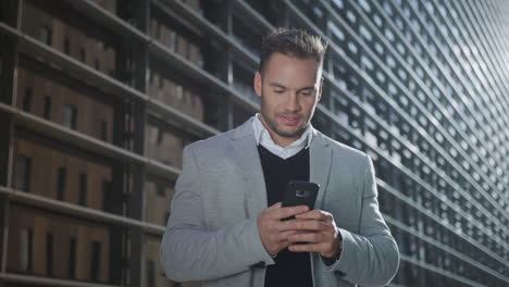 Businessman-using-smartphone-on-street.-Worker-browsing-internet-on-phone