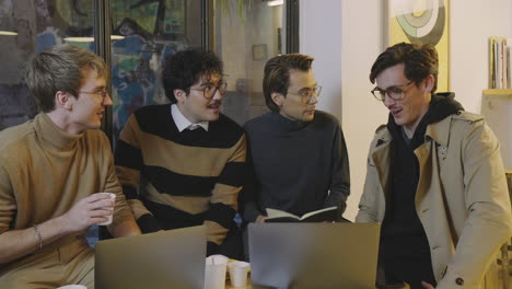 Thoughtful-businessmen-having-working-meeting-in-cafe.-Business-men-using-laptop