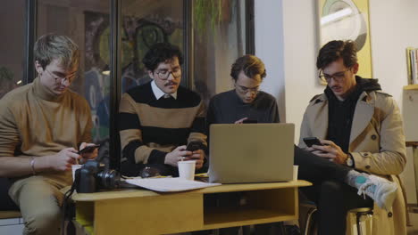 Businessmen-using-smartphones-in-cafe.-Freelancers-having-break-during-meeting