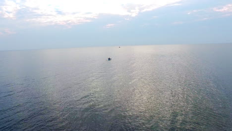 Kayaker-floating-in-sea-on-evening-sky.-Drone-view-man-training-on-kayak