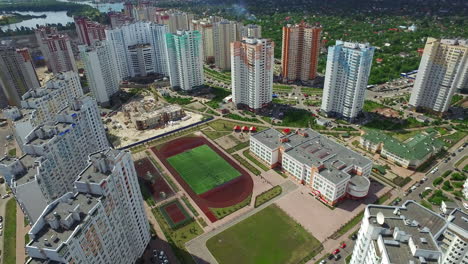 Aerial-view-residential-high-rise-building-and-school-sportground-in-schoolyard