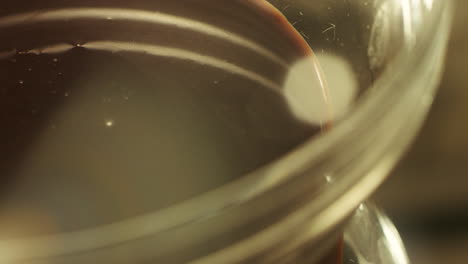 Closeup-confectioner-whipping-mixer-liquid-chocolate-in-slow-motion.