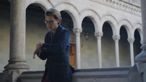 Man-checking-time-on-wristwatch-outdoors.-Businessman-waiting-for-client-outside