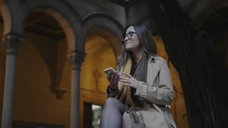 Student-talking-on-smartphone-at-university.-Woman-receiving-good-news-on-phone