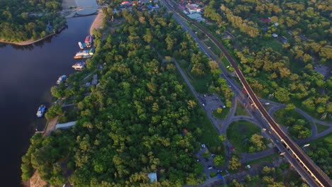 Aerial-view-car-highway-in-city.-Railway-bridge-over-river