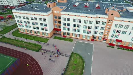 Aerial-view-schoolchild-walking-on-sport-ground-school-yard.-School-soccer-field