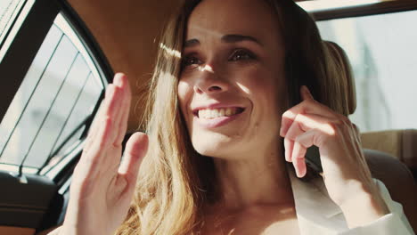 Happy-businesswoman-surprising-to-hear-good-news-on-phone-in-business-car.