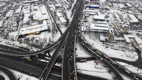Aerial-view-cars-motion-on-highway-intersection-city.-Winter-roads-in-city