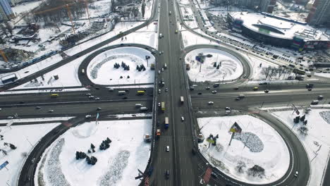 Car-driving-on-flyover-highway-winter-city.-Aerial-view-overpass-freeway-in-city