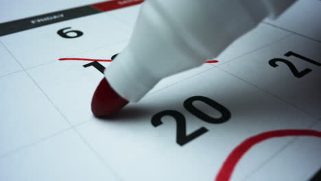 Planning-month-schedule.-Date-of-month-on-calendar-circled-by-red-marker