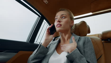 Stressed-business-woman-talking-phone-at-car.-Woman-arguing-on-phone-at-car