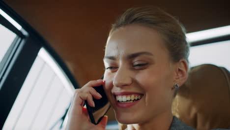 Joyful-businesswoman-talking-mobile-phone-at-vehicle.-Girl-having-phone-call