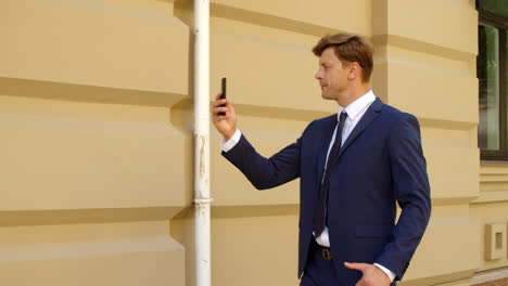Anxious-business-man-having-video-call-online-on-smartphone-outdoors