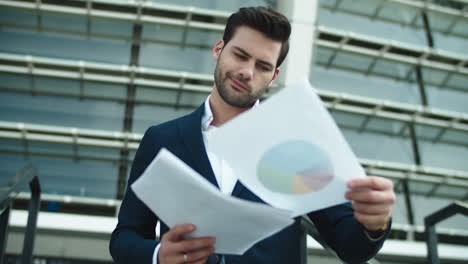 Portrait-businessman-reading-documents.-Businessman-looking-away-at-street