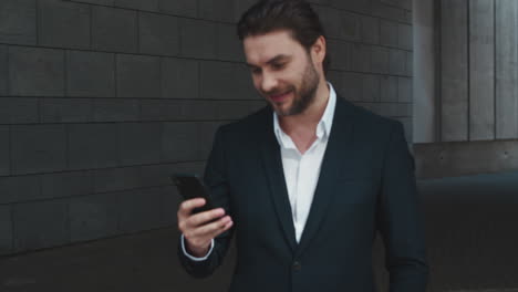 Businessman-using-smartphone-outside.-Worker-browsing-internet-online-on-street