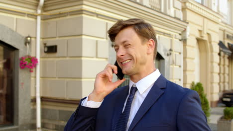 Successful-business-man-celebrating-victory-outdoors.-Businessman-call-phone
