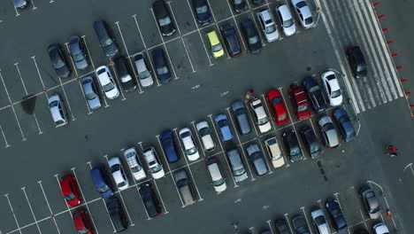Copter-filming-people-walking-at-parking.-Drone-footage-car-riding-at-parking