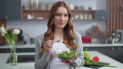 Beautiful-girl-eating-fresh-salad-at-home-kitchen.-Woman-enjoying-fresh-food
