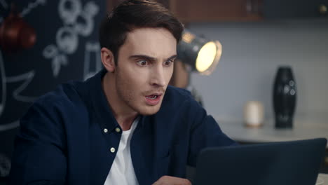 Business-man-getting-bad-results-on-computer-at-home.-Shocked-guy-feeling-upset
