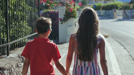 Cheerful-children-enjoying-weekend-outdoor.-Boy-and-girl-walking-down-street.