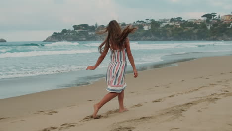Joyful-girl-having-fun-at-sea-beach.-Happy-teenager-resting-at-coastline.