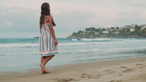 Carefree-woman-enjoying-summer-holiday-at-coastline.-Girl-walking-along-beach.