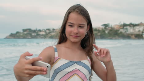 Joyful-girl-spending-time-at-seaside.-Cheerful-woman-posing-to-camera-at-beach.