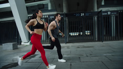 Sport-couple-jogging-at-cardio-training.-Fitness-man-and-woman-running-together
