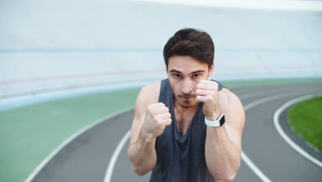 Sport-man-boxing-at-stadium.-Man-boxer-training-outside