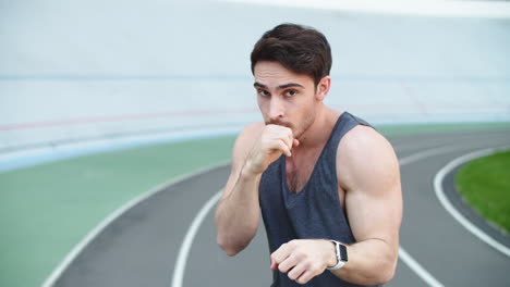 Man-boxer-exercising-at-stadium.-Sport-man-boxing-in-slow-motion-outdoor