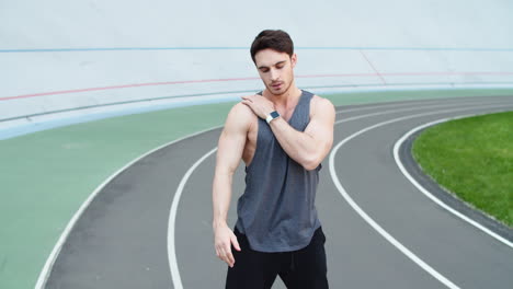 Male-runner-stretching-on-racetrack.-Sport-man-stretching-outdoors-on-stadium