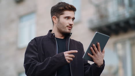 Surprised-man-looking-tablet-screen-outdoors.-Happy-guy-using-digital-tablet