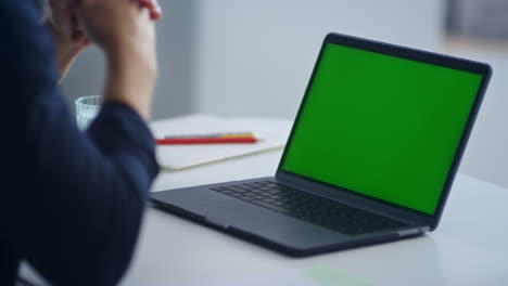 Unrecognized-man-looking-green-screen-laptop.-Businessman-working-notebook