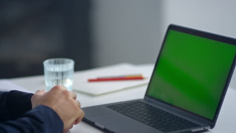 Business-man-looking-green-screen-laptop.-Man-waving-hand-after-video-call.