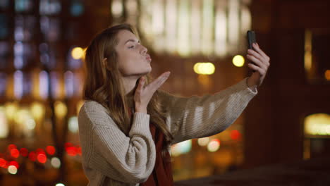 Funny-woman-making-selfie-by-mobile-phone-outside.-Cute-girl-showing-duck-lips.